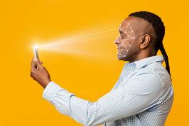 A person holding a phone that is scanning their face