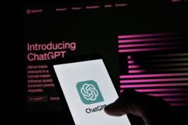 A hand holding a smartphone that is accessing Chat-GPT