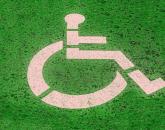 A white handicapped icon against a green background